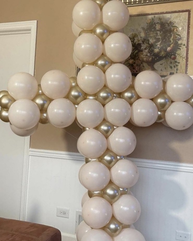 Ivory and gold balloon cross sculpture