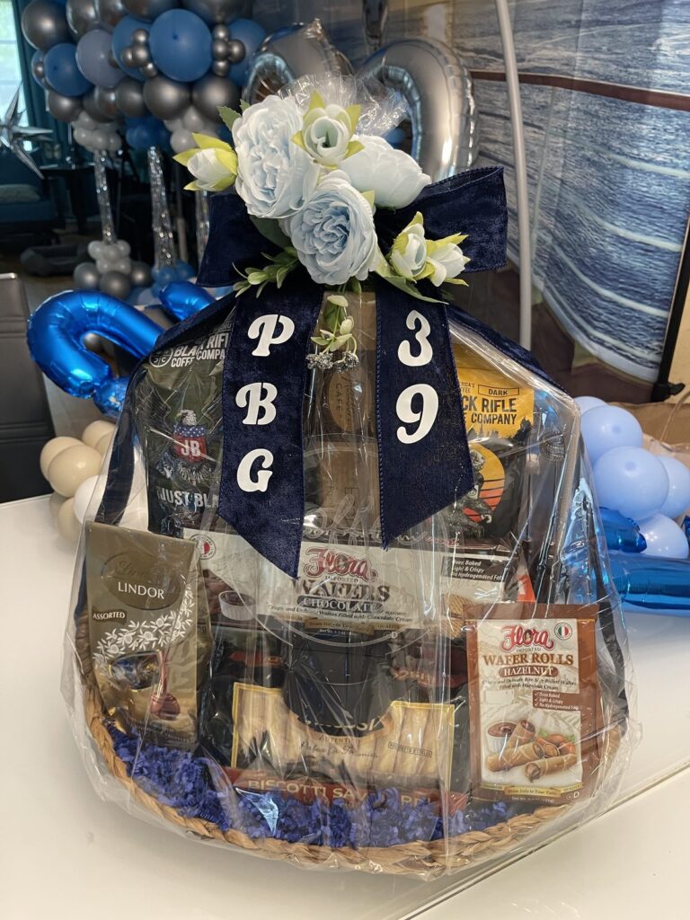 Blue and white balloon accented gift basket with monogram letters