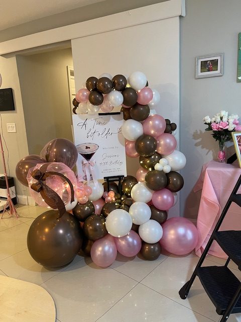 Brown, blush and white balloon garland wrapping a custom birthday backdrop