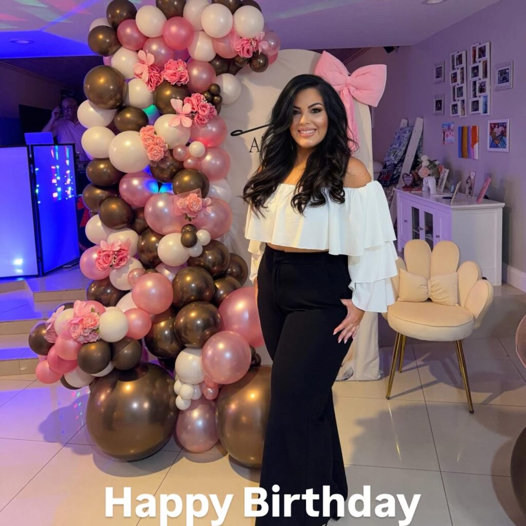 Chocolate, blush and white balloon garland framing a birthday celebrant