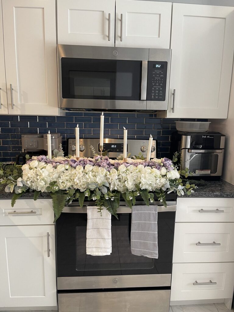 Long white floral table runner centerpiece with taper candles