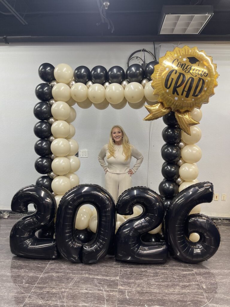 Black and ivory balloon photo frame with giant 2026 numbers and a graduation foil balloon