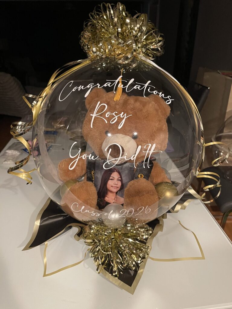 Personalized graduation stuffed balloon with a plush bear, gold tinsel and a congratulations message