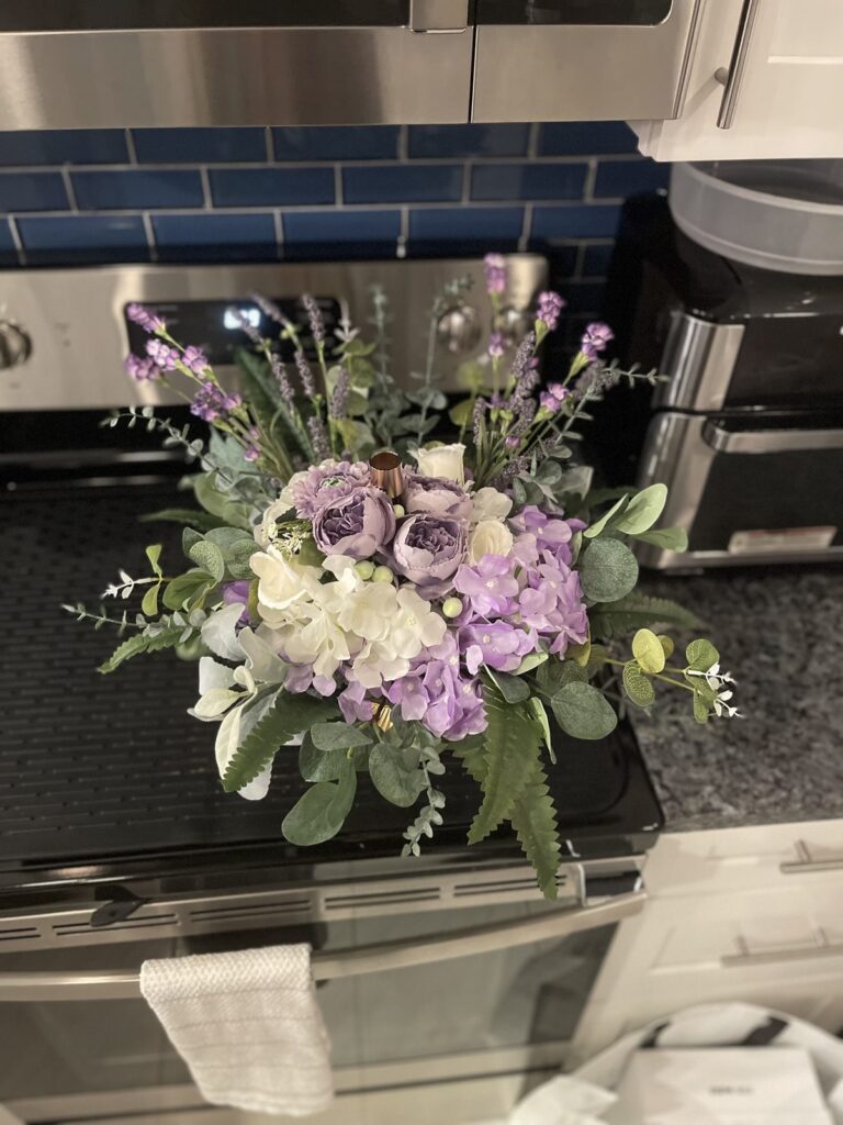 Lavender and white rose floral arrangement with greenery