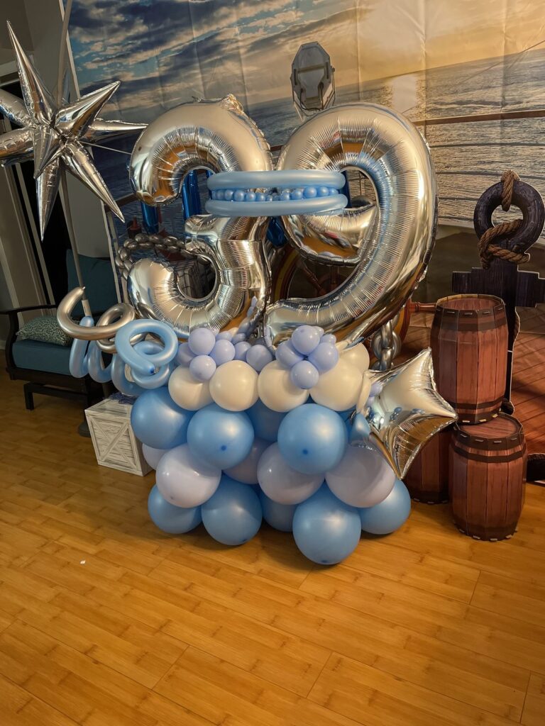 Silver foil numbers on a blue and white balloon base with star accents