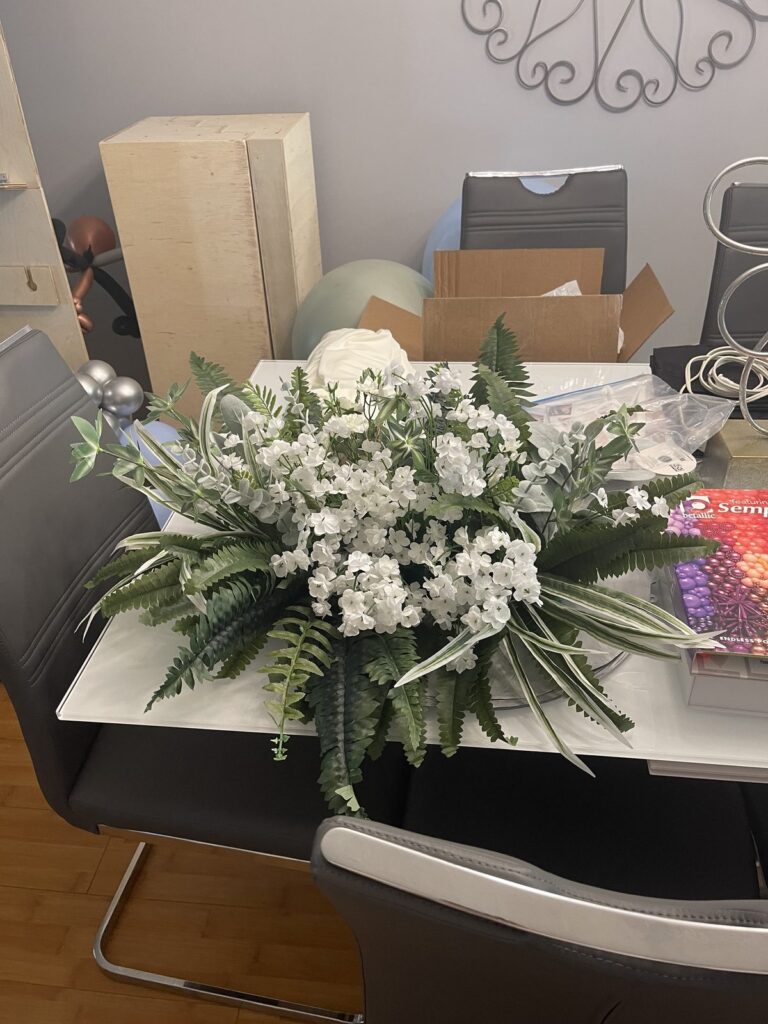 Lush white floral arrangement with greenery